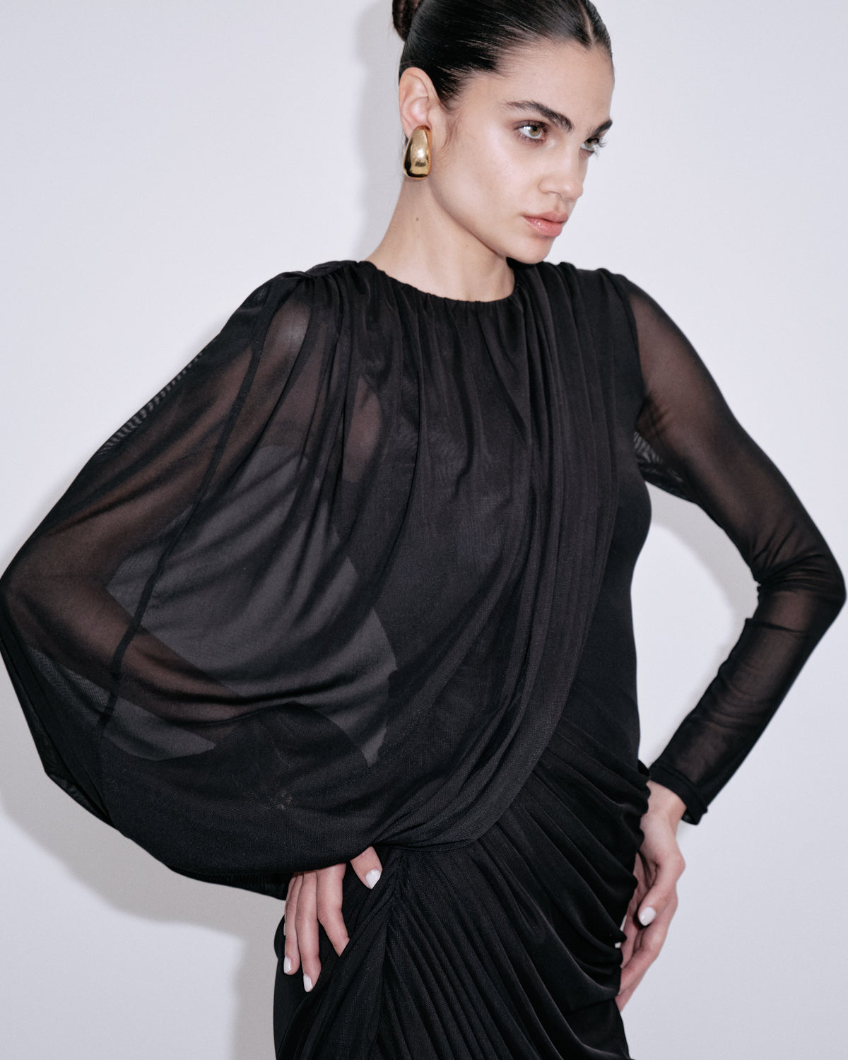 Black draped dress with sheer long sleeves and ruched bodice