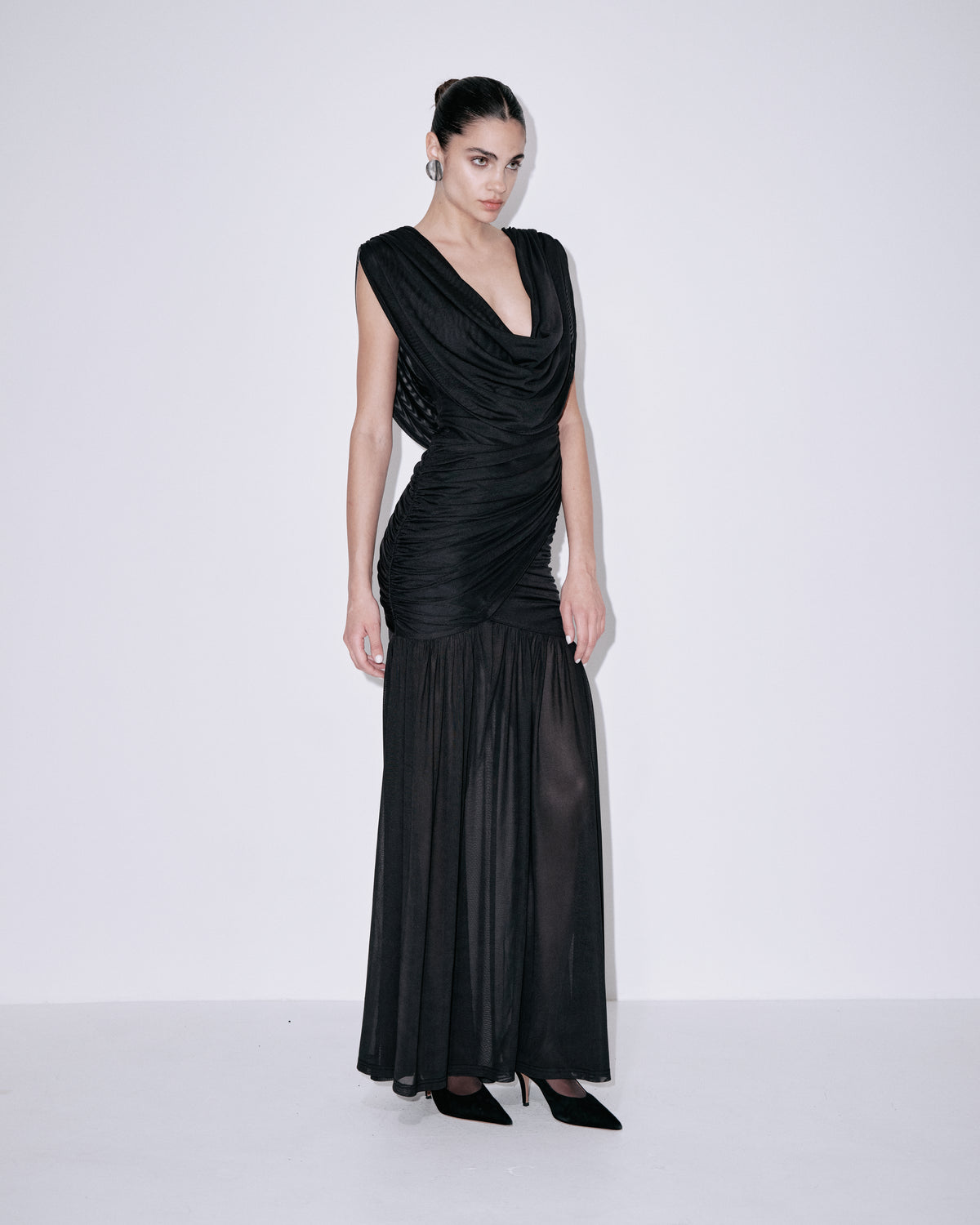 Black draped cowl-neck sleeveless dress with ruched bodice and layered pleated hem