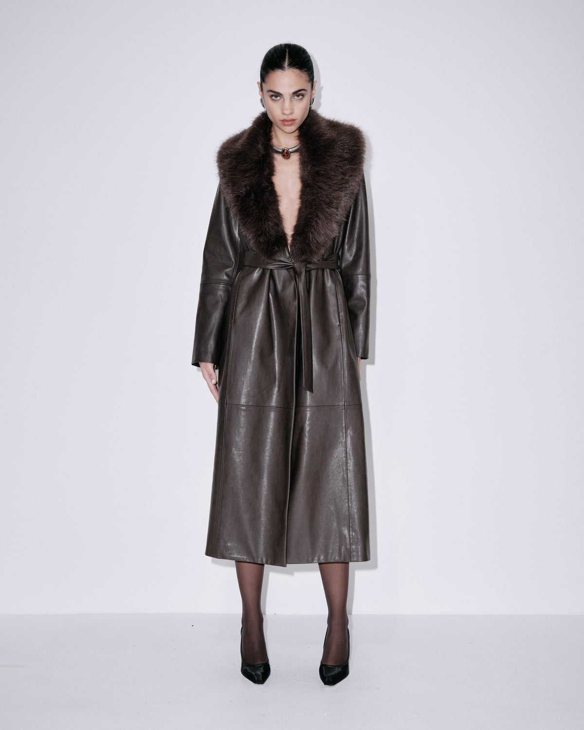 Chocolate faux-leather long coat with dark fur trim and front tie belt