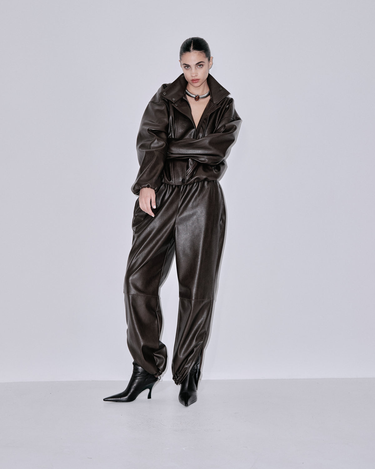 Chocolate-brown shiny jogger pants with elastic waist and tapered legs