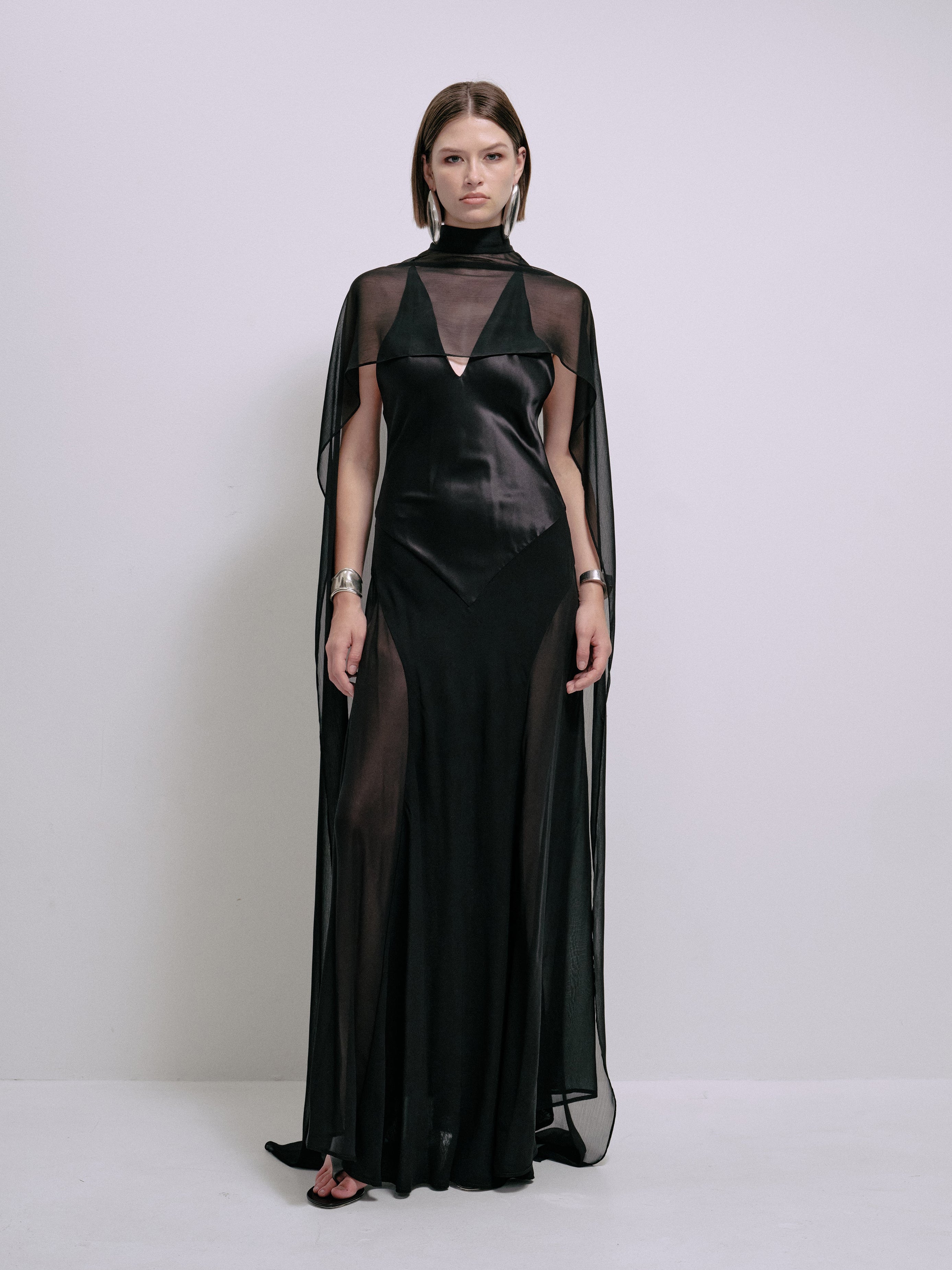 Black satin maxi dress with V neckline and sheer cape overlay