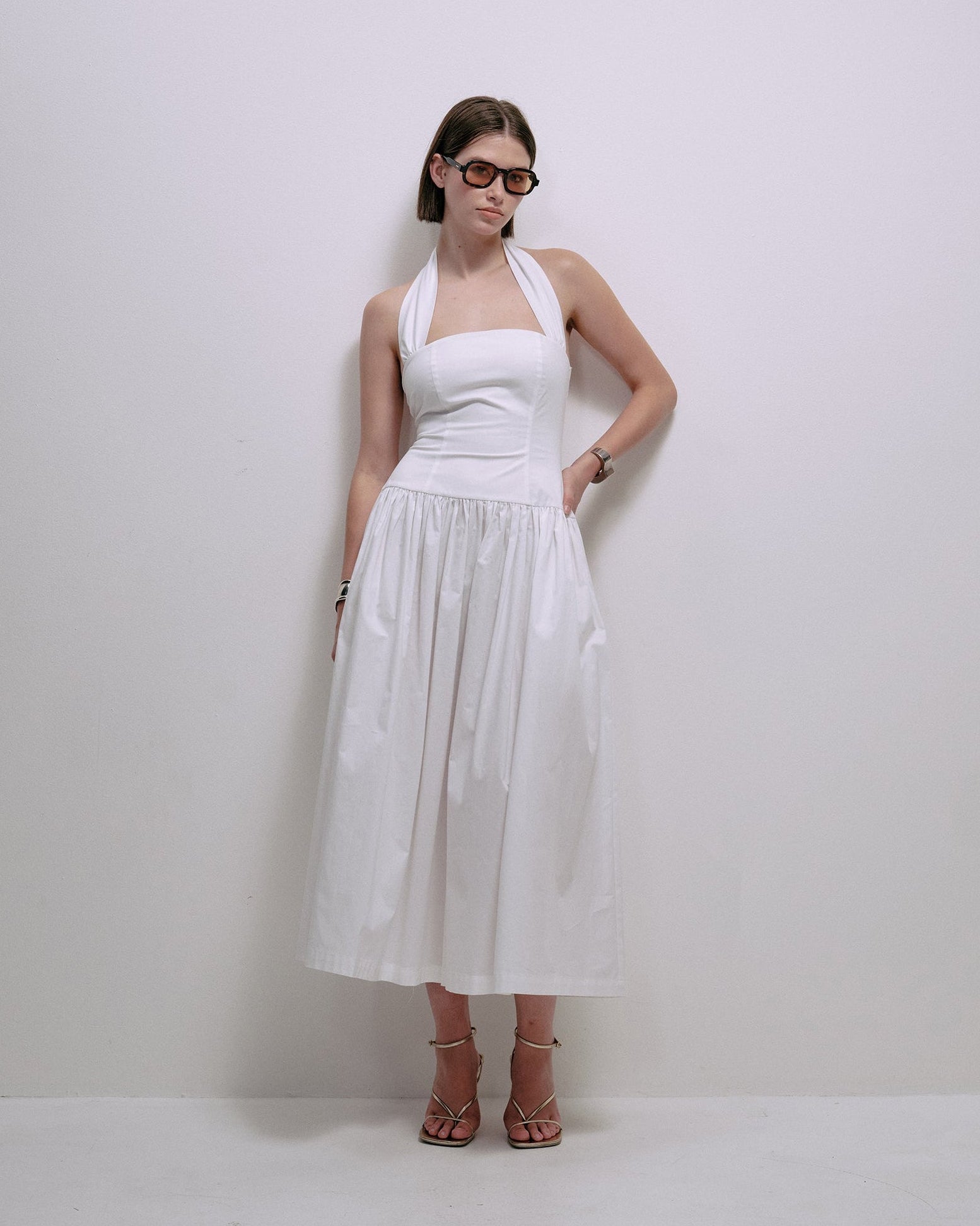 Sleeveless white midi dress with square neckline and gathered waist