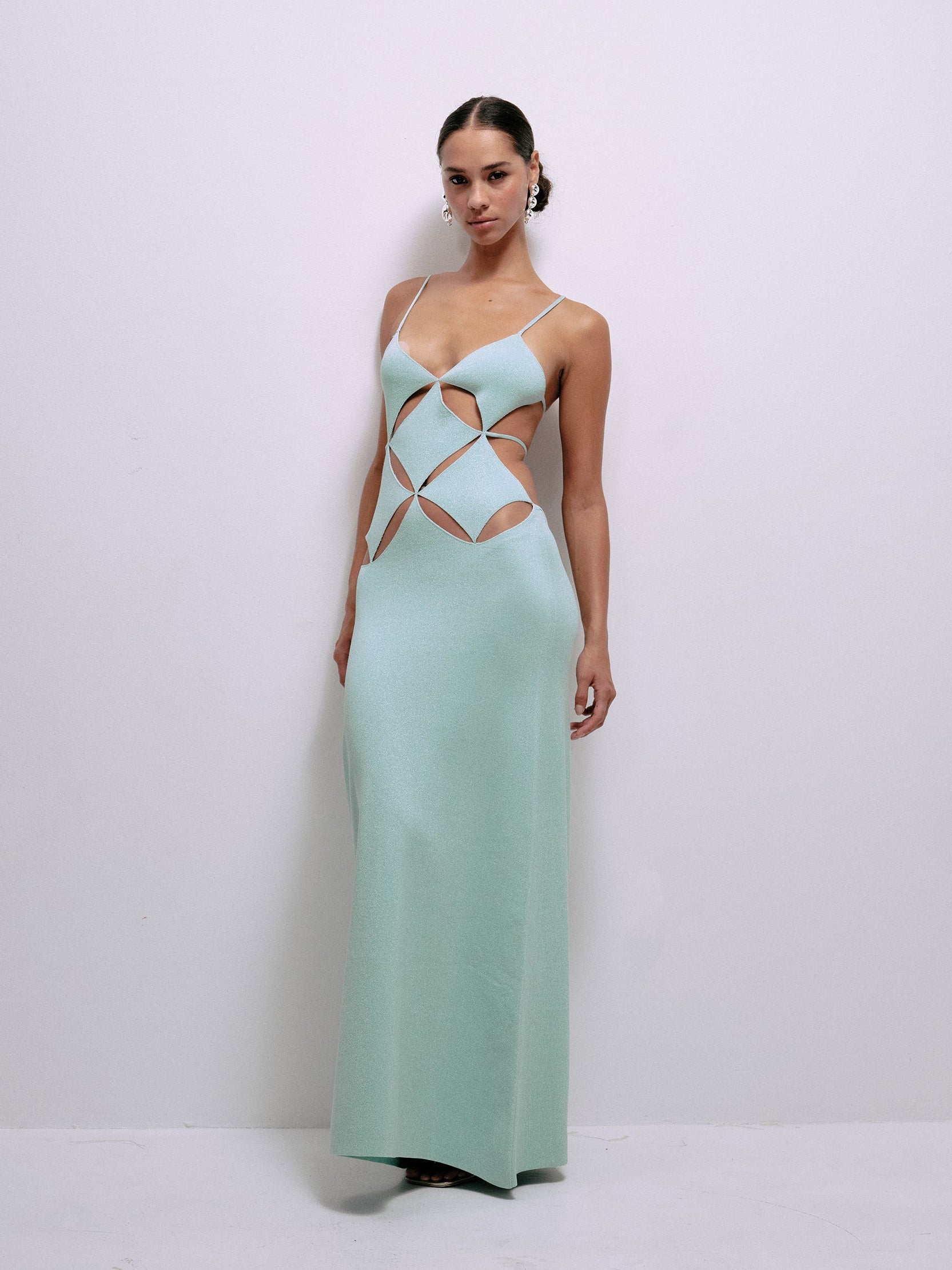 Mint spaghetti-strap maxi dress with geometric cutouts on the bodice and waist