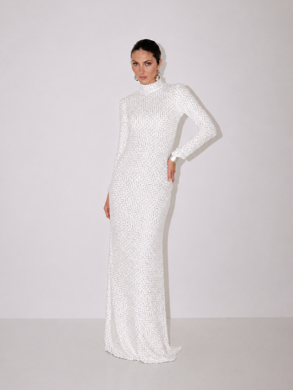 Ivory long-sleeve fitted maxi dress with high neckline and subtle flare at hem