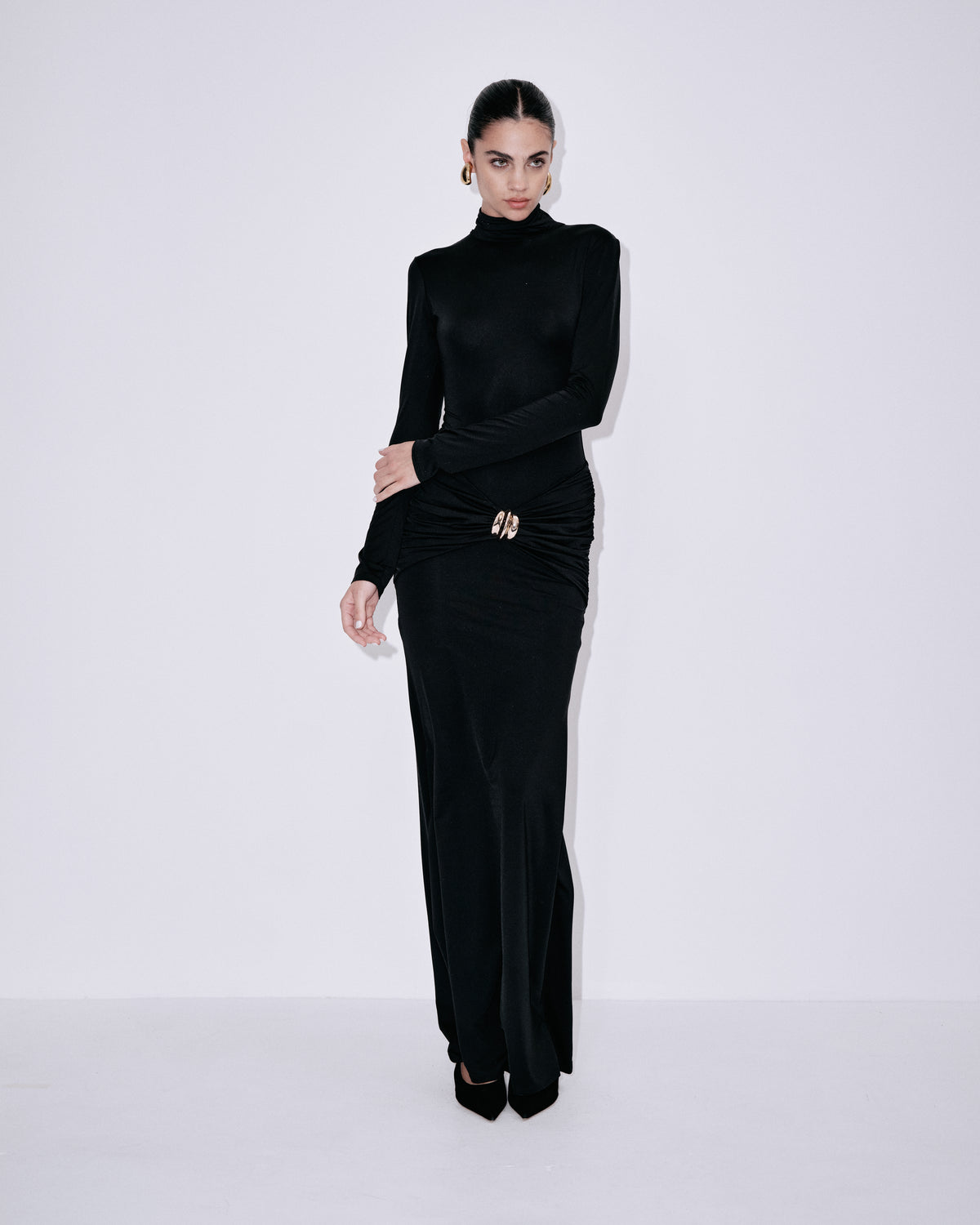 Black fitted turtleneck maxi dress with ruched waist detail and side slit