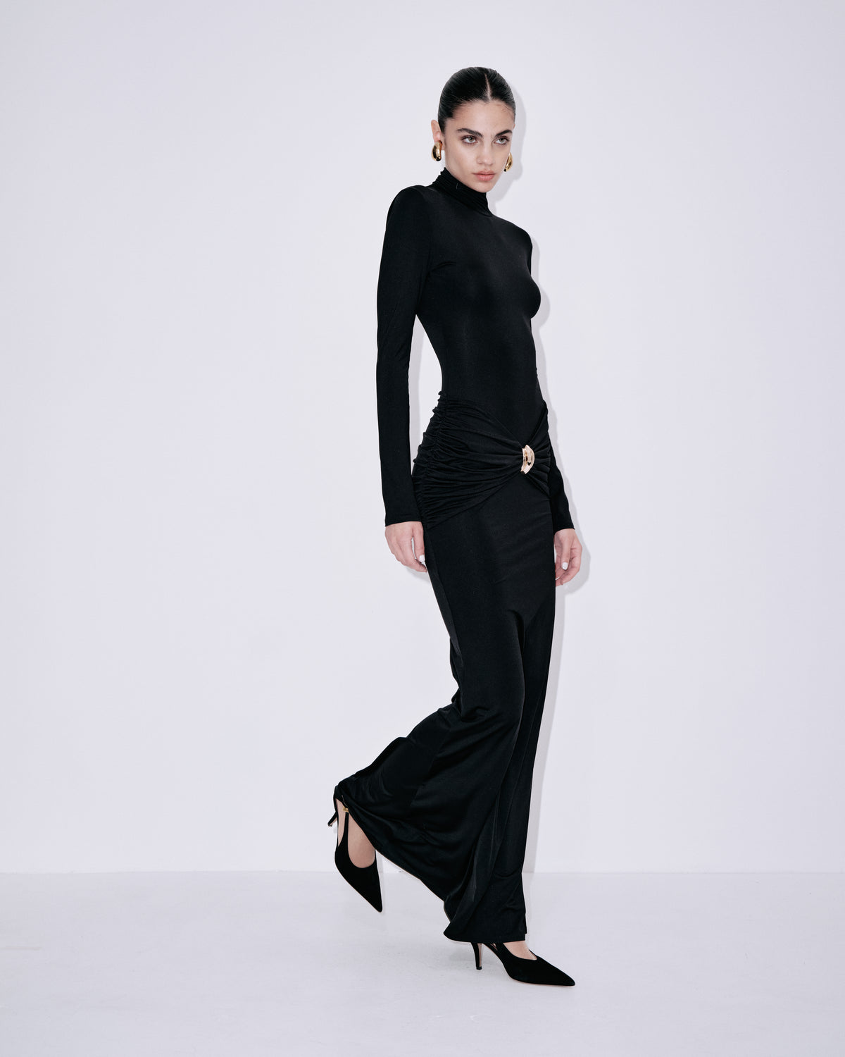 Black turtleneck maxi dress with long sleeves, ruched waist, and side slit