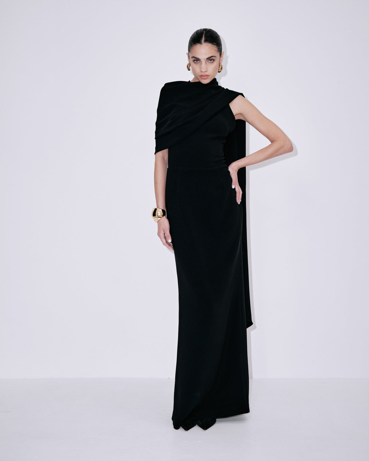 Black one-shoulder maxi dress with draped shoulder wrap and side-slit hem