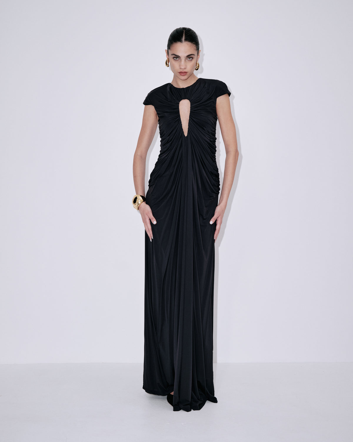 Black draped maxi dress with cap sleeves and neckline cutout