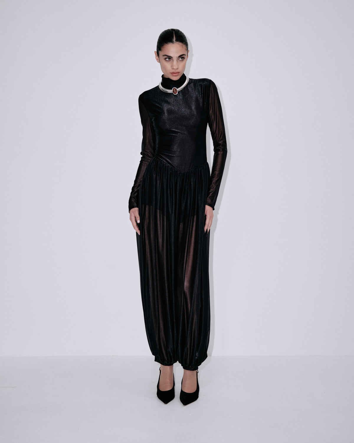 Black long-sleeve high-collar jumpsuit with pleated front and gathered wide legs