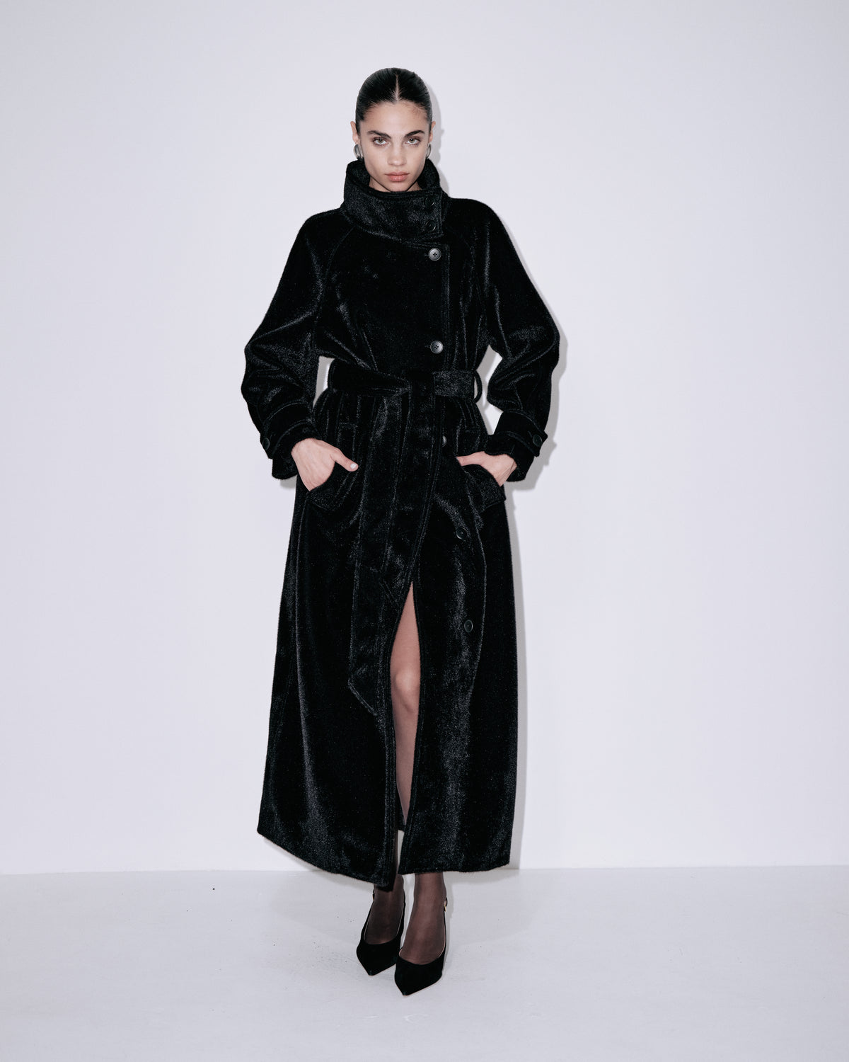 Black velvet long coat with shawl collar, button front, belted waist, side slit