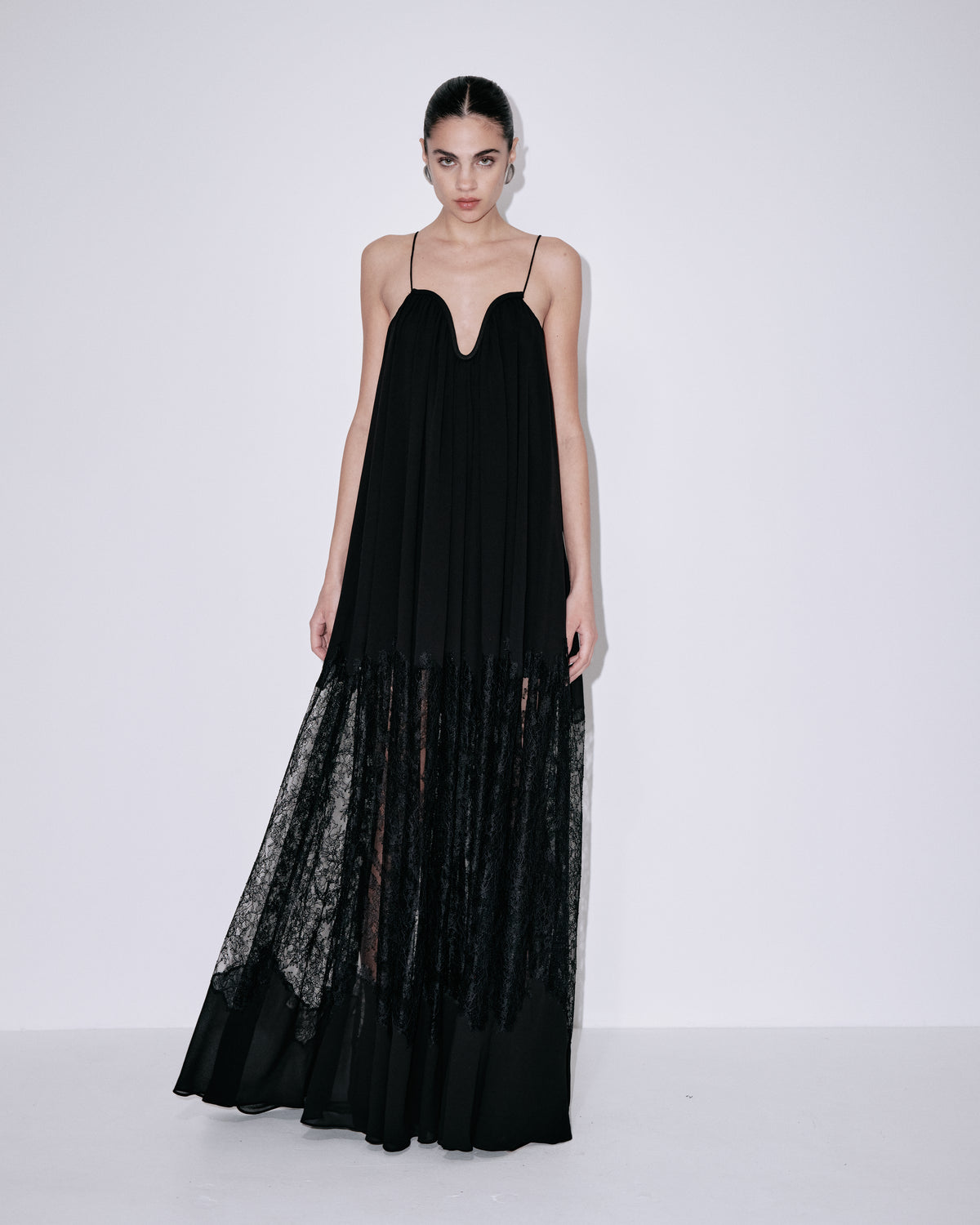 Black maxi dress with spaghetti straps, sweetheart neckline, sheer lace hem overlay