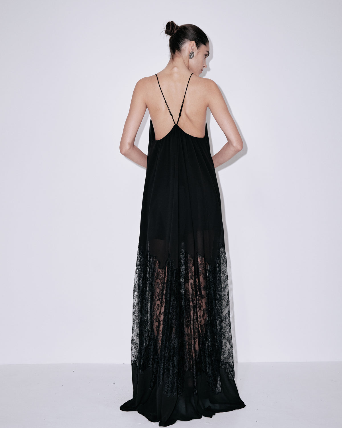 Black maxi dress with crisscross back straps, sweetheart neckline, lace hem overlay