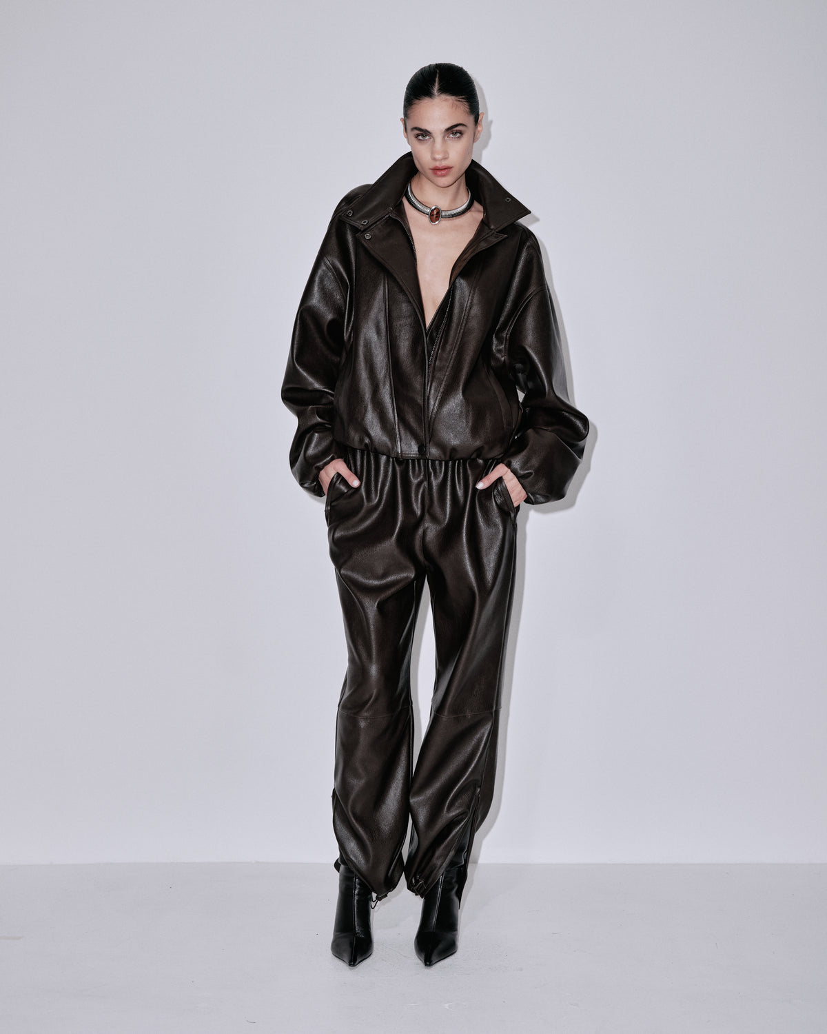 Chocolate-brown shiny jogger pants with elastic waist and tapered ankle cuffs