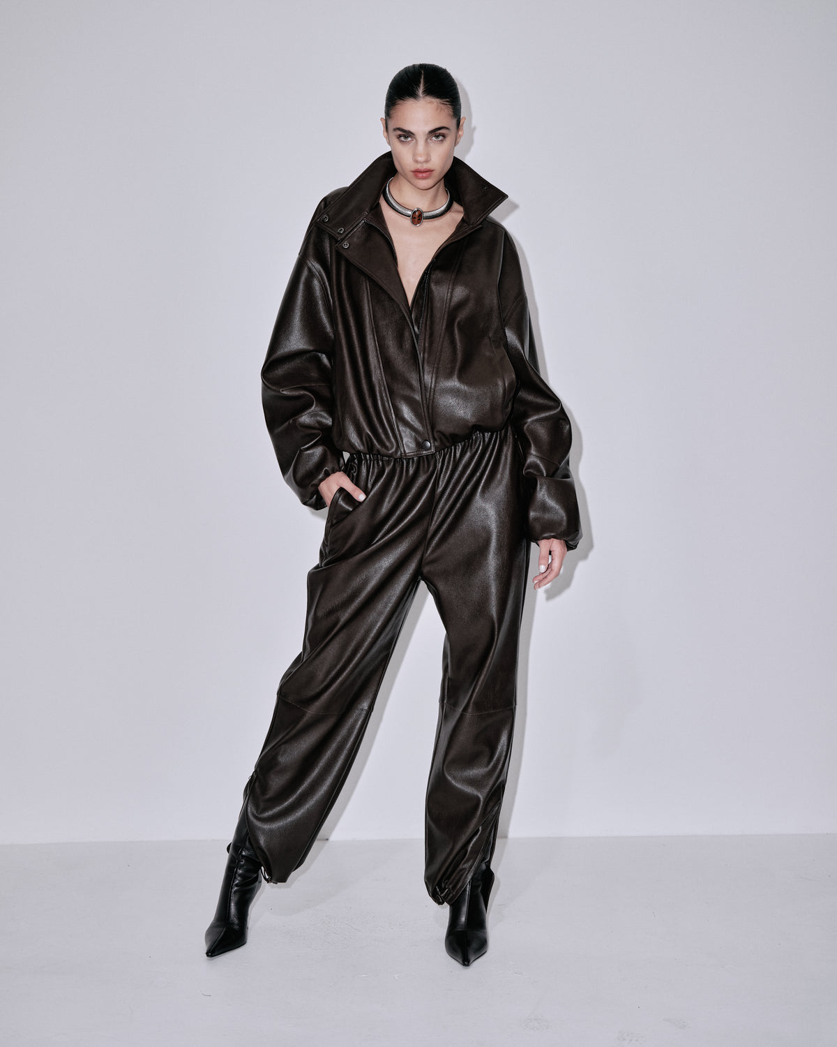 Chocolate-brown shiny jogger pants with elastic waist, gathered leg openings