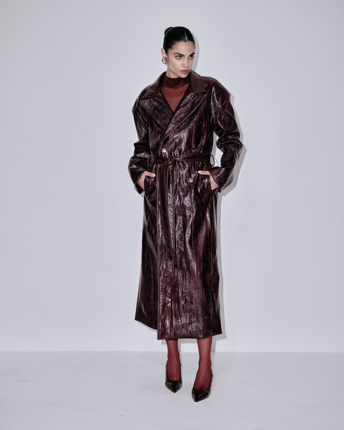 Shimmering dark berry long coat with notched lapels and cinched waist belt
