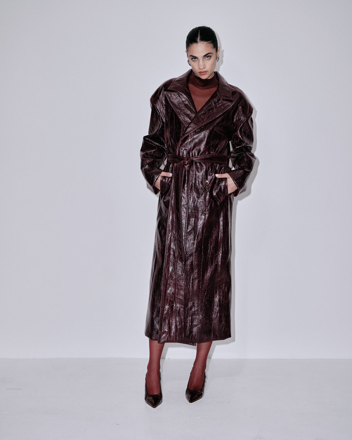 Dark metallic berry belted long coat with notched collar and flap pockets