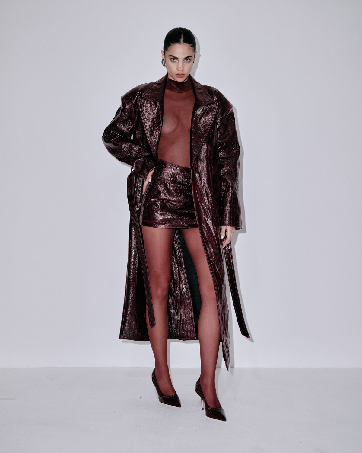 Dark burgundy metallic mini skirt with front slit and reflective surface