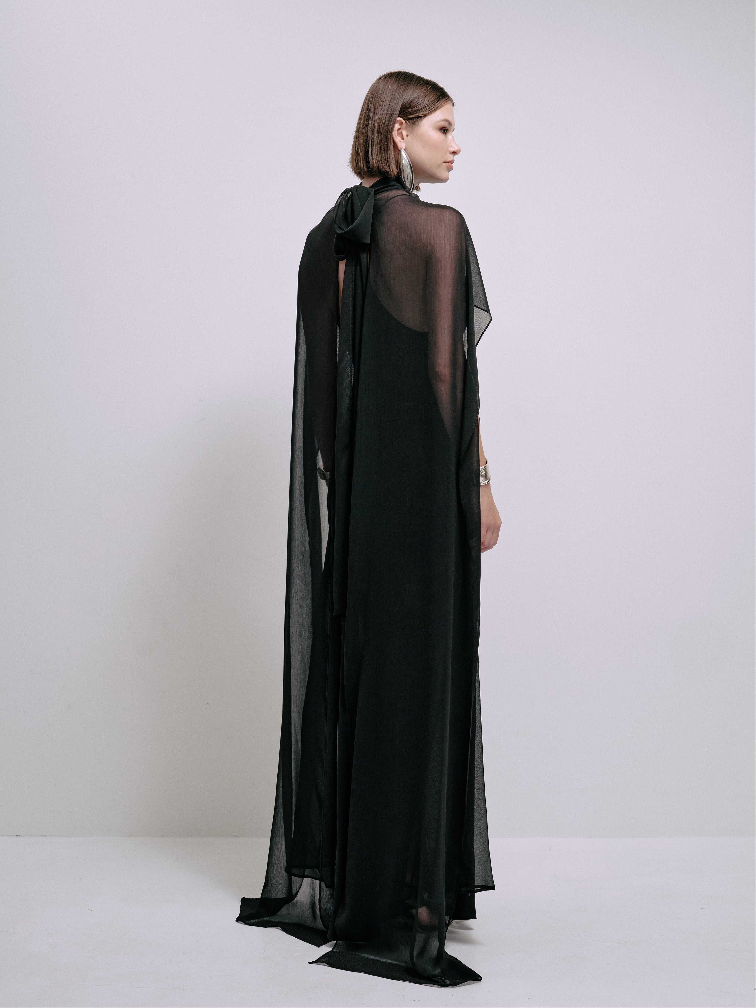 Black maxi dress with sheer back cape and halter neckline