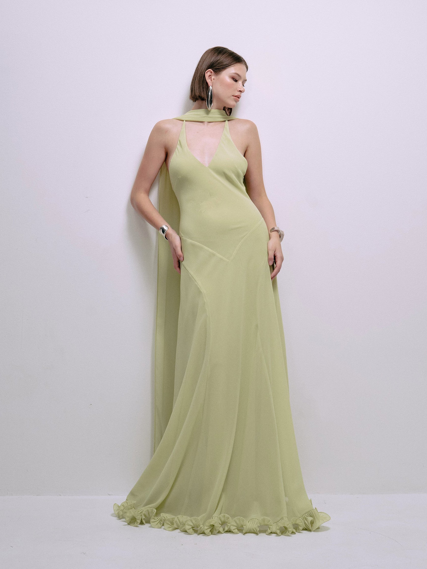 Lime halter maxi dress, side view with draped neckline and ruffled hem