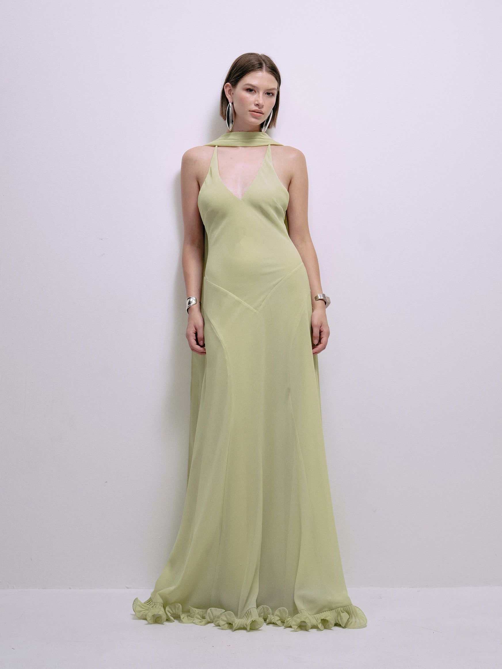 Lime halter maxi dress front view with cross-front seam and ruffled hem