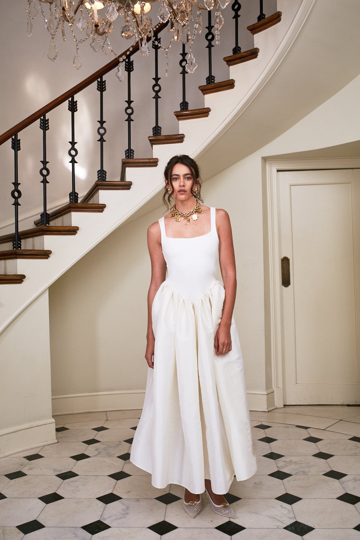 Long sleeveless white dress with contrast orange bodice and gathered waist