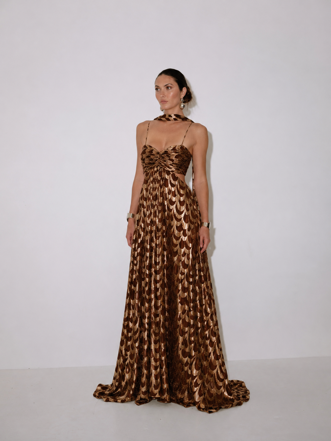 Bronze sleeveless gown with scalloped lace-like scale pattern, full length