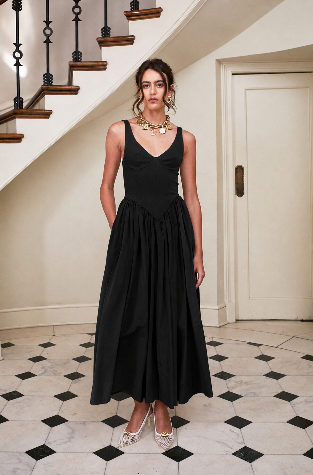 Black sleeveless V-neck midi dress with fitted bodice and gathered skirt