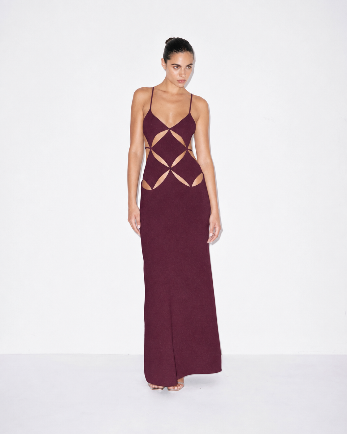 Plum maxi dress with spaghetti straps and geometric cutout pattern at bodice
