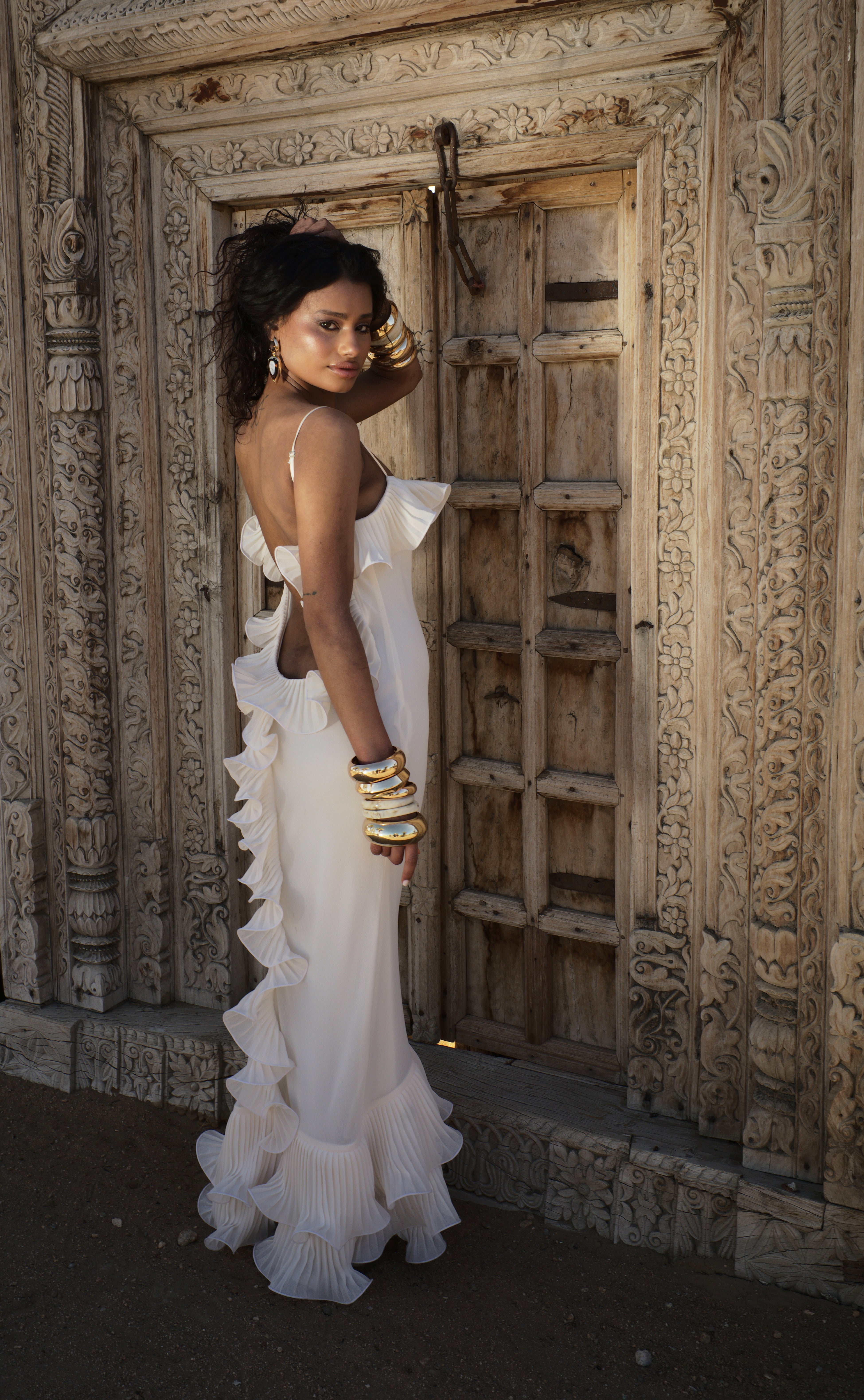 Cream sleeveless maxi dress with layered ruffle trim, side view