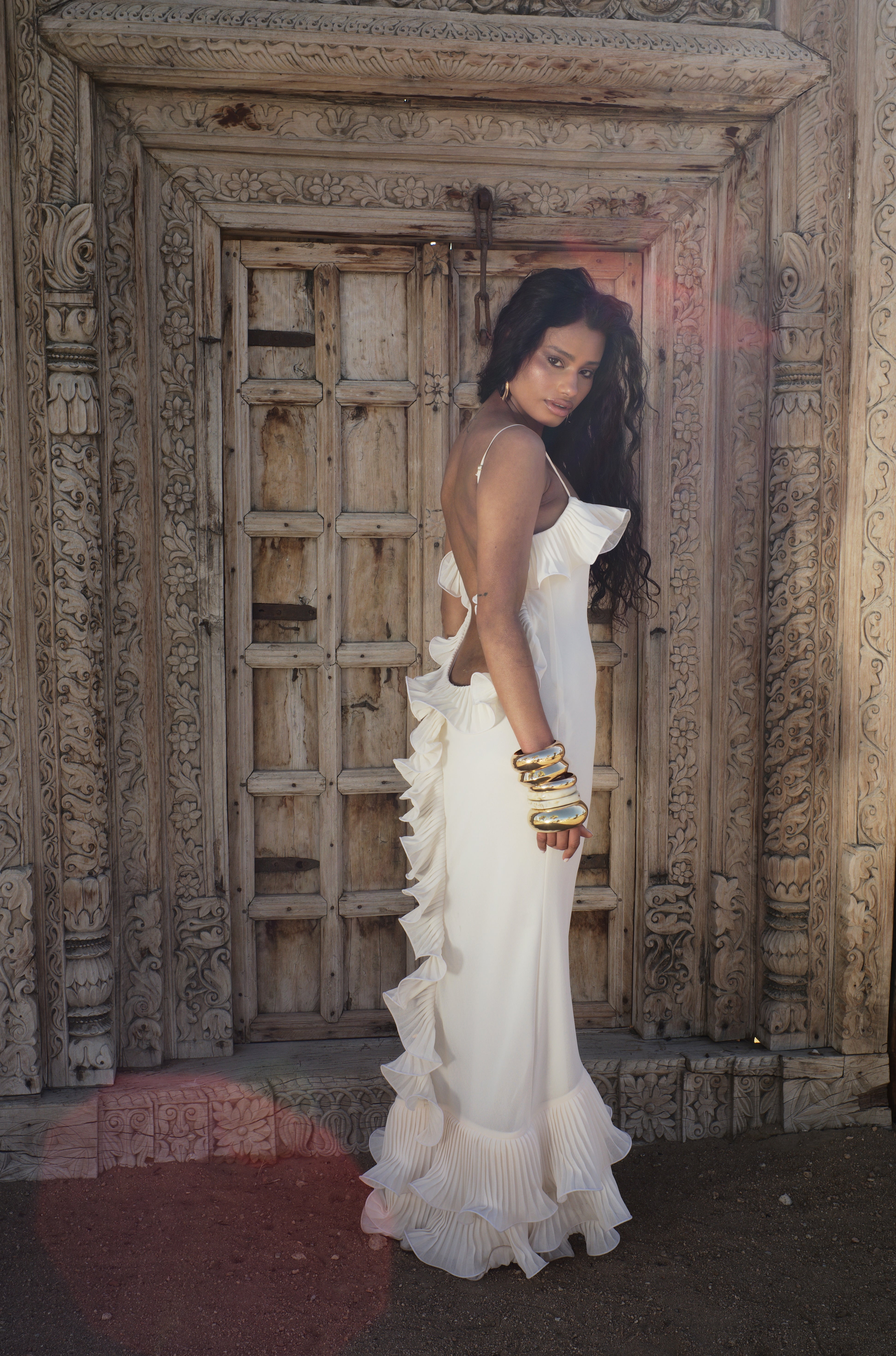 Cream sleeveless ruffle maxi dress with layered hem, side profile