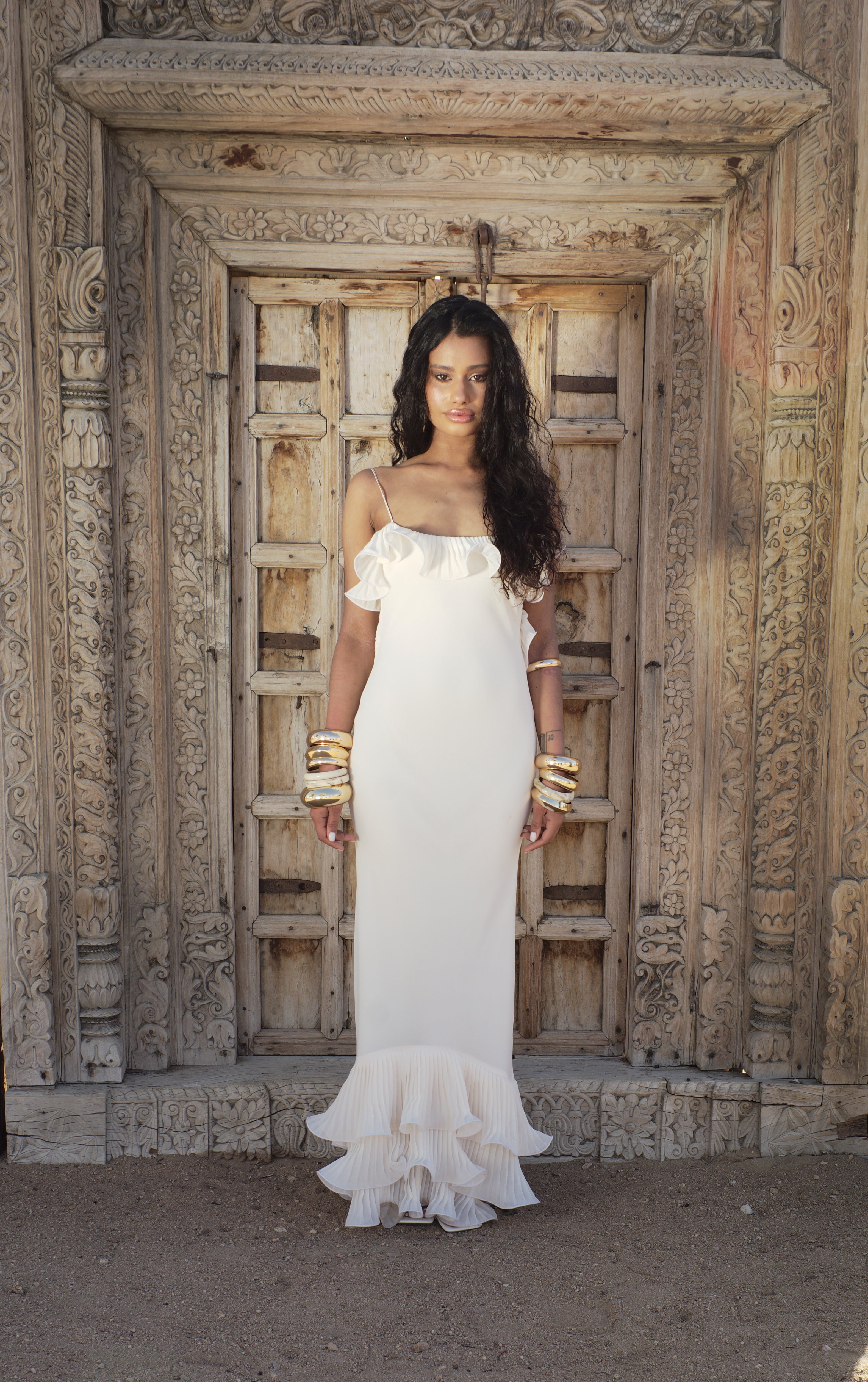 Cream sleeveless fitted maxi dress with layered ruffle hem, front view