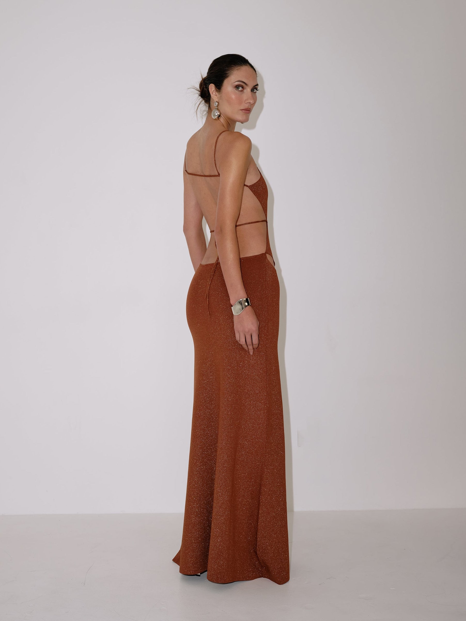Bronze glitter maxi dress with open back, V straps, and geometric cutout front